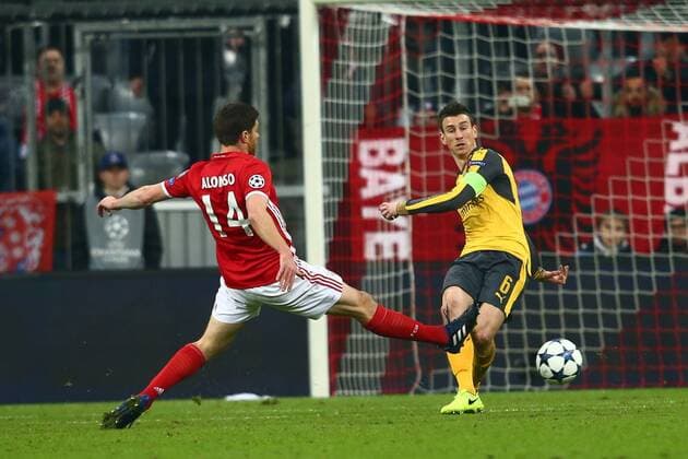 SOCCER - CL, Bayern vs Arsenal MUNICH,GERMANY,15.FEB.17 - SOCCER - UEFA Champions League, FC Bayern Muenchen vs FC Arsenal. Image shows Laurent Koscielny (Arsenal) and Xabi Alonso (Bayern). GEPAxpictures xFelixxRoittner