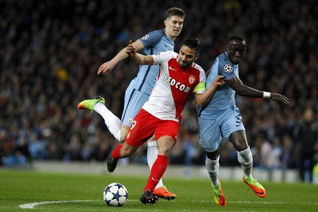 Football - 2016 2017 UEFA Champions League - Round of Sixteen, First Leg: Manchester City vs. Monaco Radamel Falcao Garcia of Monaco holds off Bacary Sagna and John Stones of Manchester City during the match at the Etihad Stadium. COLORSPORT 