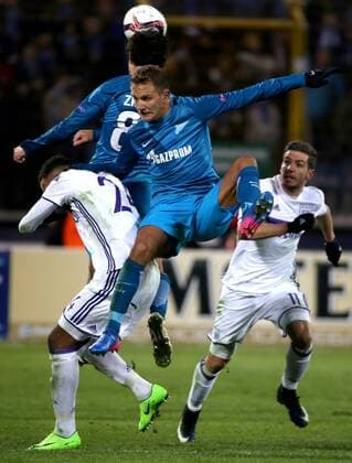 ST PETERSBURG, RUSSIA - FEBRUARY 23, 2017: Zenit St Petersburg s Domenico Criscito (C), RSC Anderlecht Brusselsâ€™ Isaac Thelin (L) and Alexandru Chipciu in action in their 2016-17 UEFA Europa League Round of 32, 2nd leg football match at Petrovsky Stadium. Zenit St Petersburg won the game 3-1. Alexander Demianchuk TASS  TS042622