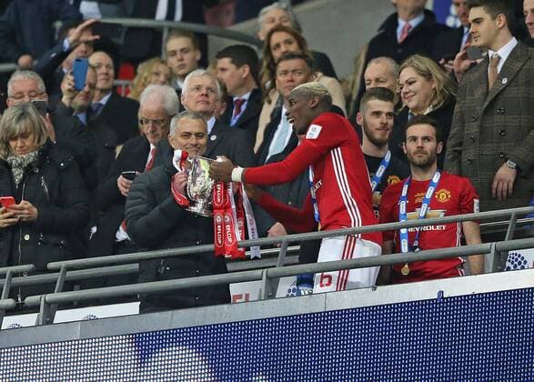 February 26th 2017, Wembley Stadium, London, England; EFL League Cup final, Southampton v Manchester United ManU Paul Pogba of Manchester United hands the EFL Trophy to Manchester United Jose Mourinho from the stands xJohnxPatrickxFletcherx  ActionPlus11851126