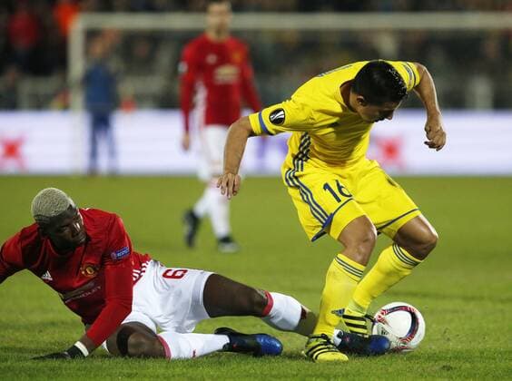 ROSTOV-ON-DON, RUSSIA - MARCH 9, 2017: FC Manchester United ManU s Paul Pogba (L) and FC Rostov s Christian Noboa fight for the ball in Leg 1 of their 2016-17 UEFA Europa League Round of 16 football match at Olimp-2 Stadium. Valery Matytsin TASS  TS043C3F
