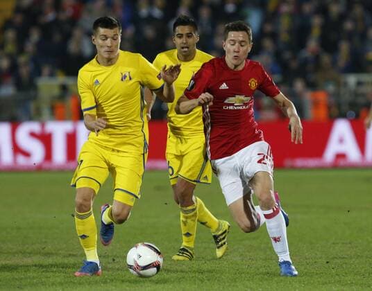 FuÃŸball, EL, FK Rostow - Manchester United ROSTOV-ON-DON, RUSSIA - MARCH 9, 2017: FC Rostov s Dmitry Poloz, Christian Noboa and FC Manchester United ManU s Ander Herrera (L-R) fight for the ball in Leg 1 of their 2016-17 UEFA Europa League Round of 16 football match at Olimp-2 Stadium. Valery Matytsin TASS  TS043C46