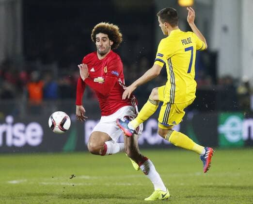 ROSTOV-ON-DON, RUSSIA - MARCH 9, 2017: FC Manchester United ManU s Marouane Fellaini (L) and FC Rostov s Dmitry Poloz fight for the ball in Leg 1 of their 2016-17 UEFA Europa League Round of 16 football match at Olimp-2 Stadium. The game ended in a 1-1 draw. Valery Matytsin TASS  TS043C4C