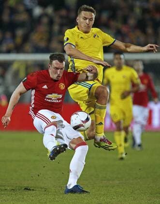 ROSTOV-ON-DON, RUSSIA - MARCH 9, 2017: FC Manchester United ManU s Phil Jones (L) and FC Rostov s Alexander Bukharov fight for the ball in Leg 1 of their 2016-17 UEFA Europa League Round of 16 football match at Olimp-2 Stadium. The game ended in a 1-1 draw. Valery Matytsin TASS  TS043C4E