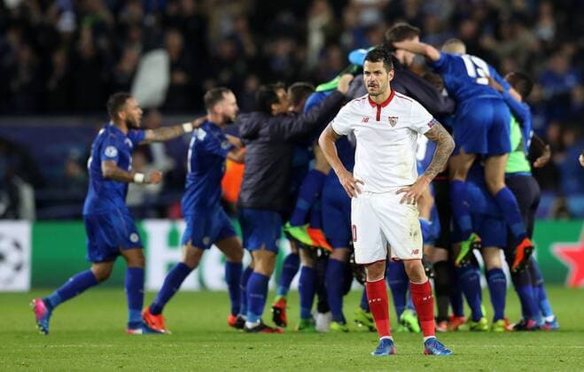 Football - 2016 2017 UEFA Champions League - Round of Sixteen, Second Leg: Leicester City 1 vs. Sevilla 2 Vitolo of Sevilla reacts as Leicester City celebrate after the match at the King Power Stadium. 