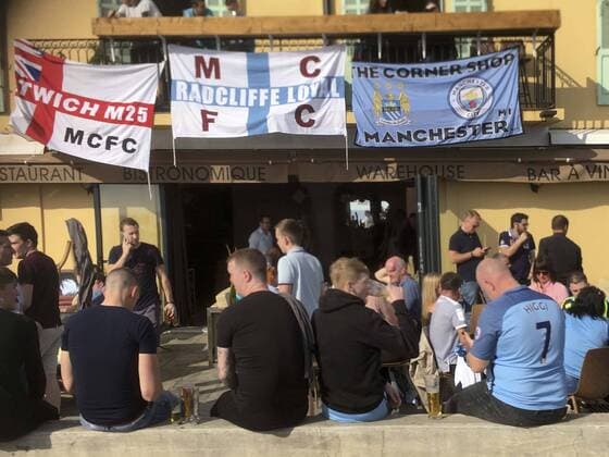 Football - UEFA Champions League - Round of Sixteen: AS Monaco 3 vs. Manchester City 5 Manchester City fans & their flags outside a bar on the Promenade Des Anglais in Nice before the match, at the Stade Louis II. COLORSPORT WINSTON BYNORTH 