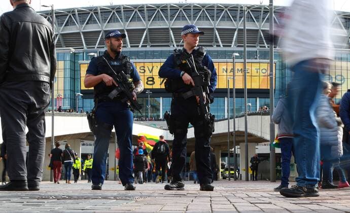 Armed police patrol outside Wembley Stadium before the England v Lithuania World Cup Qualifier played at Wembley Stadium, on March 26, 2017. 