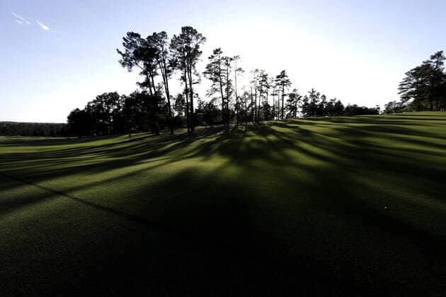 The sun sets behind the first hole fairway after a practice round on Tuesday at the 2017 Masters Tournament at Augusta National Golf Club in Augusta, Georgia on April 4, 2017.  AUG20170404147 JOHNxANGELILLO