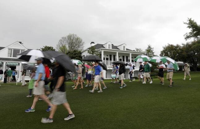 Patrons carrying umbrellas in the rain exit the grounds after the traditional par 3 contest gets canceled due to approaching rain and thunderstorms on Wednesday at the 2017 Masters Tournament at Augusta National Golf Club in Augusta, Georgia on April 5, 2017.  AUG20170405603 JOHNxANGELILLO