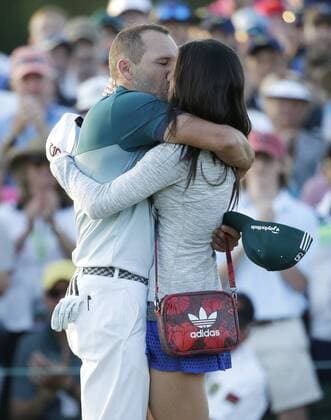 Sergio Garcia of Spain hugs fiancee Angela Akins when he celebrates on the 18th green after he wins the 2017 Masters Tournament at Augusta National Golf Club in Augusta, Georgia on April 9, 2017. Garcia defeated Justin Rose of England in a playoff to win his first major championship.  AUG20170409614 JOHNxANGELILLO