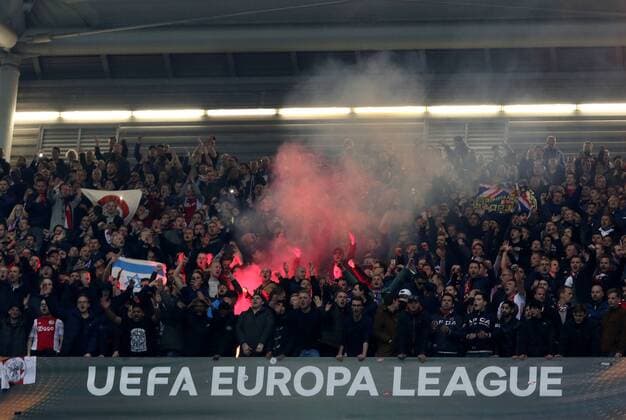 Fans von Ajax Amsterdam zünden im Gästeblock der Veltins-Arena Pyros beim Europa League Viertelfinal Rückspiel (Saison 2016 17) FC Schalke 04 - Ajax Amsterdam Copyright: Thomas Pakusch
