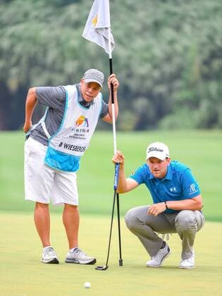 Bernd Wiesberger of Austria considers a hit in the final match of the 2017 Shenzhen International Golf Tournament in Shenzhen city, south China s Guangdong province, 23 April 2017. Austrian Bernd Wiesberger beat England s Tommy Fleetwood in a playoff on Sunday (23 April 2017) to win the Shenzhen International. Wiesberger went into the final round with a three-shot lead and eight shots ahead of Fleetwood but the Englishman fired a 63 to finish tied at 16 under. Wiesberger s 71 featured par saves on the 12th and 17th and he nearly hit the pin with his approach to the last hole but was forced to settle for a par and a trip back up the 18th. Wiesberger hit his drive in the playoff over the water off the tee and ended up in the bank while Fleetwood played safely onto the fairway and found the heart of the green with his second shot. The pressure was on Wiesberger and he delivered, placing his approach to five feet and making the putt for a birdie. Wiesberger wins playoff to capture Shenzhen International  20170423_84893