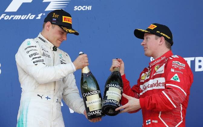 SOCHI, RUSSIA - APRIL 30, 2017: Frst-placed Mercedes AMG Petronas F1 driver (L) Valtteri Bottas and third-placed Scuderia Ferrari F1 Team driver Kimi Raikkonen (L) of Finland open champagne on the podium after the 2017 Formula One Russian Grand Prix at the Sochi Autodrom racing circuit. Vyacheslav Prokofyev TASS  TS04A3AA