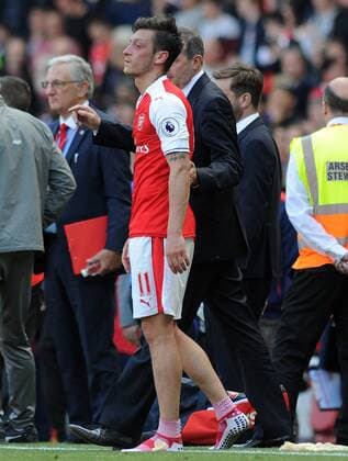 Football - 2016 2017 Premier League - Arsenal vs. Everton A dejected Mesut Ozil of Arsenal after failing to qualify for the Champions League after the match at The Emirates. COLORSPORT ANDREW COWIE 