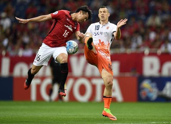 Takuya Aoki of Japan s Urawa Red Diamonds, left, challenges Marcelo Toscano of South Korea s Jeju United in their second Round of 16 match during the AFC Champions League 2017 in Urawa, Saitama, Japan, 31 May 2017. Urawa Red Diamonds defeated Jeju United 3-0 in their second Round of 16 match during the 2017 AFC Champions League in Saitama, Japan, 31 May 2017. Urawa Red Diamonds beats Jeju United in second Round of 16 match at AFC Champions League  20170531_62337