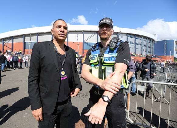 Stan Collymore speaks to a police officer during the FIFA World Cup WM Weltmeisterschaft Fussball Qualifying match at Hampden Park Stadium, Glasgow Picture date 10th June 2017. Picture credit should read: David Klein Sportimage EDITORIAL USE ONLY. No use with unauthorised audio, video, data, fixture lists, club league logos or live services. Online in-match use limited to 120 images, no video emulation. No use in betting, games or single club league player publications.