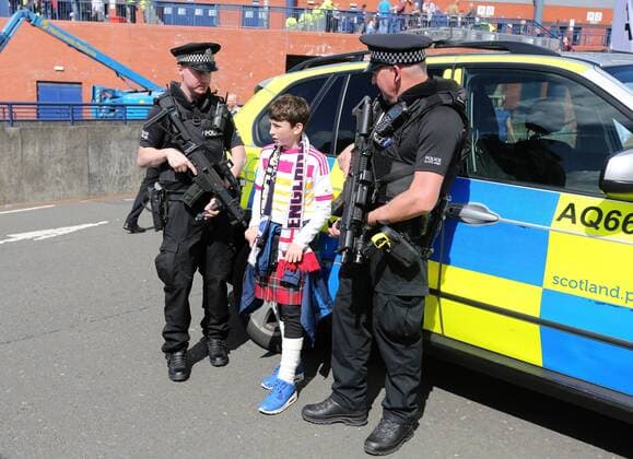 A young fan speaks to armed police during the FIFA World Cup WM Weltmeisterschaft Fussball Qualifying match at Hampden Park Stadium, Glasgow Picture date 10th June 2017. Picture credit should read: David Klein Sportimage EDITORIAL USE ONLY. No use with unauthorised audio, video, data, fixture lists, club league logos or live services. Online in-match use limited to 120 images, no video emulation. No use in betting, games or single club league player publications.