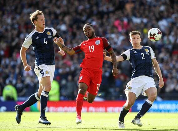 Scotland s Christophe Berra and Kieran Tierney tussle with England s Raheem Sterling during the FIFA World Cup WM Weltmeisterschaft Fussball Qualifying match at Hampden Park Stadium, Glasgow Picture date 10th June 2017. Picture credit should read: David Klein Sportimage EDITORIAL USE ONLY. No use with unauthorised audio, video, data, fixture lists, club league logos or live services. Online in-match use limited to 120 images, no video emulation. No use in betting, games or single club league player publications.