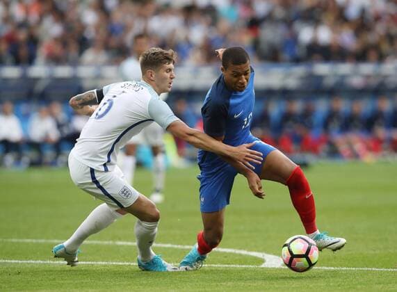 France s Kylian Mbappe tussles with England s John Stones during the Friendly match at Stade De France Stadium, Paris Picture date 13th June 2017. Picture credit should read: David Klein Sportimage EDITORIAL USE ONLY. No use with unauthorised audio, video, data, fixture lists, club league logos or live services. Online in-match use limited to 120 images, no video emulation. No use in betting, games or single club league player publications.