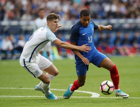 France s Kylian Mbappe tussles with England s John Stones during the Friendly match at Stade De France Stadium, Paris Picture date 13th June 2017. Picture credit should read: David Klein Sportimage EDITORIAL USE ONLY. No use with unauthorised audio, video, data, fixture lists, club league logos or live services. Online in-match use limited to 120 images, no video emulation. No use in betting, games or single club league player publications.