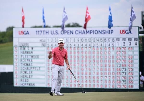 Brian Harman picks up his ball after making par on the 18th hole during round 3 of the 117th U.S. Open golf tournament at Erin Hill golf course on June 17, 2017 in Erin, Wisconsin.  WIS20170617122 BRIANxKERSEY