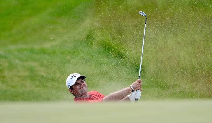 Patrick Reed blasts out of a greenside bunker on the 18th hole during round 3 of the 117th U.S. Open golf tournament at Erin Hill golf course on June 17, 2017 in Erin, Wisconsin.  BK18346 BRIANxKERSEY