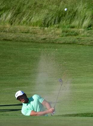 Brooks Koepka blasts from the No. 14 bunker during the final round of the 117th U.S. Open golf tournament at Erin Hills golf course on June 18, 2017, in Erin, Wisconsin.  WIS20170618559 KEVINxDIETSCH