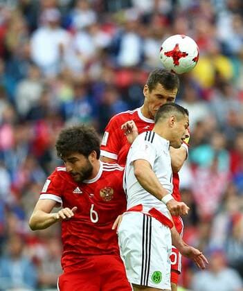 Mexico vs. Russia SAO PETERSBURGO, MO - 24.06.2017: MEXICO VS. RUSSIA - Javier Hernandez of Mexico contests bid with Vasin Viktor and Dzhikya Georgy of Russia during a match between Mexico and Russia valid for the third round of the 2017 Confederations Cup on Saturday (24) held at the Kazan Arena in Kazan, Russia. (Photo: Heuler Andrey DiaEsportivo Fotoarena) x1343486x  HeulerxAndrey