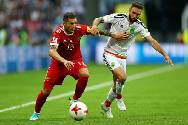 Mexico vs. Russia SAO PETERSBURGO, MO - 24.06.2017: MEXICO VS. RUSSIA - Miguel Layun of Mexico contests bid with Kudriashov Fedor of Russia during a match between Mexico and Russia valid for the third round of the Confederations Cup 2017, on Saturday (24), held at the Kazan Arena in Kazan, Russia. (Photo: Heuler Andrey DiaEsportivo Fotoarena) x1343581x  HeulerxAndrey