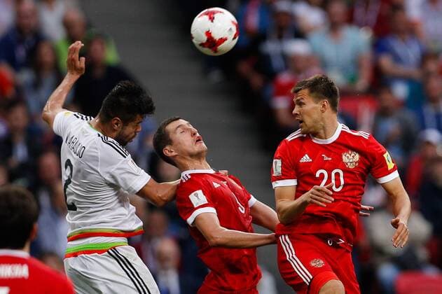 Mexico vs. Russia SAO PETERSBURGO, MO - 24.06.2017: MEXICO VS. RUSSIA - ARAUJO Nestor of Mexico dispute ball with SHISHKIN Roman and KANUNNIKOV Maksim of Russia during match between Mexico and Russia valid for the third round of the Confederations Cup 2017 on Saturday (24) held Arena Kazan in Kazan, Russia. (Photo: Marcelo Machado de Melo Fotoarena) x1343588x  MarceloxMachadoxdexMelo