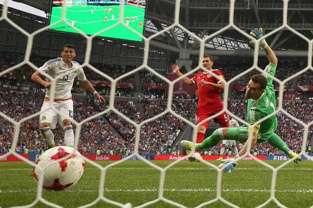 KAZAN, RUSSIA - JUNE 24, 2017: Mexico s Hector Moreno (L), Russia s Viktor Vasin (C) and goalkeeper Igor Akinfeyev in action in their 2017 FIFA Confederations Cup First Stage Group A football match at Kazan Arena Stadium; Mexico won the game 2-1. Yegor Aleyev TASS  TS054A0C
