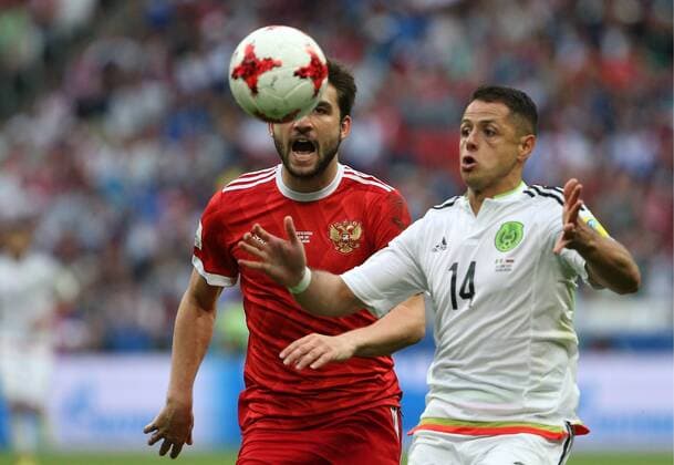 KAZAN, RUSSIA - JUNE 24, 2017: Russia s Georgy Dzhikiya (L), and Mexico s Javier Hernandez in action in their 2017 FIFA Confederations Cup First Stage Group A football match at Kazan Arena Stadium; Mexico won the game 2-1. Yegor Aleyev TASS  TS054A43