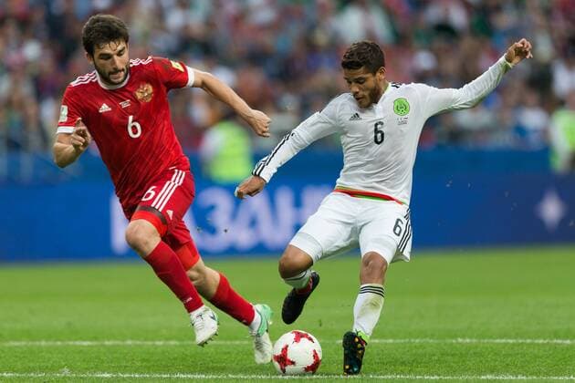 (170625) -- KAZAN, June 25, 2017 -- Jonathan Dos Santos(R) of Mexico vies with Georgy Dzhikya of Russia during group A match between Russia and Mexico at the 2017 FIFA Confederations Cup in Kazan, Russia, on June 24, 2017. Mexico won 2-1. ) (SP)RUSSIA-KAZAN-FIFA-CONFED CUP-RUS VS MEX BaixXueqi 