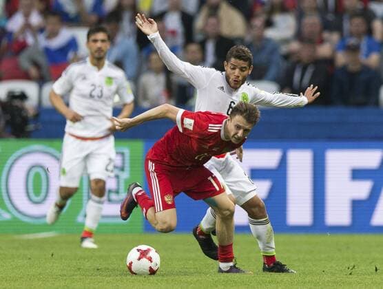 (170625) -- KAZAN, June 25, 2017 -- Jonathan Dos Santos(R) of Mexico vies with Aleksandr Golovin(Front) of Russia during group A match between Russia and Mexico at the 2017 FIFA Confederations Cup in Kazan, Russia, on June 24, 2017. Mexico won 2-1. ) (SP)RUSSIA-KAZAN-FIFA-CONFED CUP-RUS VS MEX BaixXueqi 