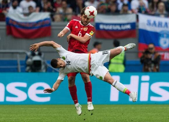 (170625) -- KAZAN, June 25, 2017 -- Georgy Dzhikya (Top) of Russia vies with Javier Hernandez of Mexico during group A match between Russia and Mexico at the 2017 FIFA Confederations Cup in Kazan, Russia, on June 24, 2017. Mexico won 2-1. ) (SP)RUSSIA-KAZAN-FIFA-CONFED CUP-RUS VS MEX EvgenyxSinitsyn 
