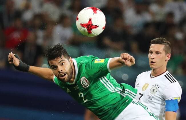 SOCHI, RUSSIA - JUNE 29, 2017: Mexico s Nestor Araujo (L) and Germany s Julian Draxler fight for the ball in their 2017 FIFA Confederations Cup semifinal football match at Fisht Stadium. Artyom Korotayev TASS  TS055834