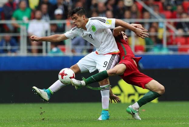 MOSCOW, RUSSIA â€“ JULY 2, 2017: Mexico s Raul Jimenez (L) and Portugal s Luis Neto fight for tha ball in their 2017 FIFA Confederations Cup third place football match at Spartak Stadium. Portugal won the game 2-1 in extra time and claimed bronze medals. Sergei Savostyanov TASS  TS055C9A