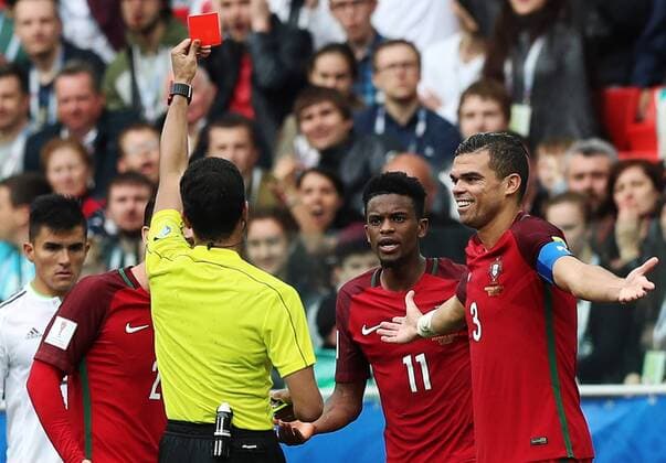 MOSCOW, RUSSIA â€“ JULY 2, 2017: Referee Fahad Al-Mirdasi (yellow) shows a red card to Portugal s Nelson Semedo (2nd R) in their 2017 FIFA Confederations Cup third place football match against Mexico at Spartak Stadium. Portugal won the game 2-1 in extra time and claimed bronze medals. Sergei Savostyanov TASS  TS055CB0