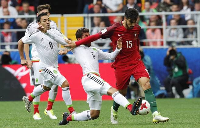 MOSCOW, RUSSIA â€“ JULY 2, 2017: Mexico s Marco Fabian, Jonathan dos Santos and Portugal s Andre Gomes (L-R) fight for the ball in their 2017 FIFA Confederations Cup third place football match at Spartak Stadium. Portugal won the game 2-1 in extra time and claimed bronze medals. Mikhail Japaridze TASS  TS055CAA