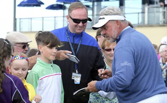 July 5th 2017, Portstewart Golf Club, Portstewart, Northern Ireland; Dubai Duty Free Irish Open Golf Championship; Pro-Am Tournament; Darren Clarke (NIR) takes time sign autographs for some young fans xNigelxCookex  ActionPlus11897943