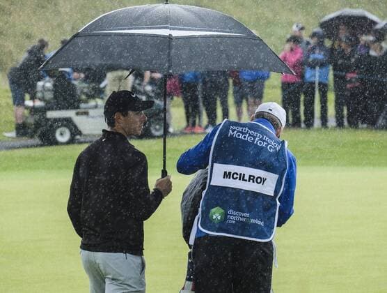 July 6th 2017, Portstewart Golf Club, Portstewart, Northern Ireland; Dubai Duty Free Irish Open Golf Championship; Day1; Rory Mcllroy (NIR) takes shelter under his umbrella as a rain shower passes over xNigelxCookex  ActionPlus11898286