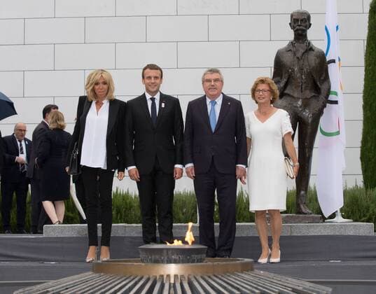 (170711) -- LAUSANNE, July 11,2017 -- French President Emmanuel Macron (2nd L) and his wife Brigitte Macron (1st L), International Olympic Committee (IOC) President Thomas Bach (2nd R) and his wife Claudia Bach pose for picutres in front of the Pierre de Coubertin statue at Olympic Museum in Lausanne, Switzerland, July 10, 2017. Members of IOC will hold a session for presentations by the campaign teams for Los Angeles and Paris on July 11th and 12th. ) (SP)SWITZERLAND-LAUSANNE Olympic Games Olympische Spiele Olympia OS 2024 BID XuxJinquan 