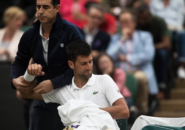 (170712) -- LONDON, July 12, 2017 -- Novak Djokovic of Serbia receives treatment during the men s singles fourth round match with Adrian Mannarino of France at the Championship Wimbledon 2017 in London, Britain on July 11, 2017. Novak Djokovic won 3-0. )(wll) (SP)BRITAIN-LONDON-TENNIS-WIMBLEDON-DAY 8 JinxYu 