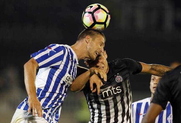 (170712) -- BELGRADE, July 12, 2017 -- Partizan s Uros Djurdjevic (C) vies with Buducnost s Momcilo Raspopovic during UEFA Champions League qualifying football match between Partizan and Buducnost in Belgrade, Serbia on July 11. 2017. Partizan won 2-0.) (SP)SERBIA-BELGRADE-SOCCER-UCL- QUALIFICATIONS-PARTIZAN-BUDUCNOST PredragxMilosavljevic 