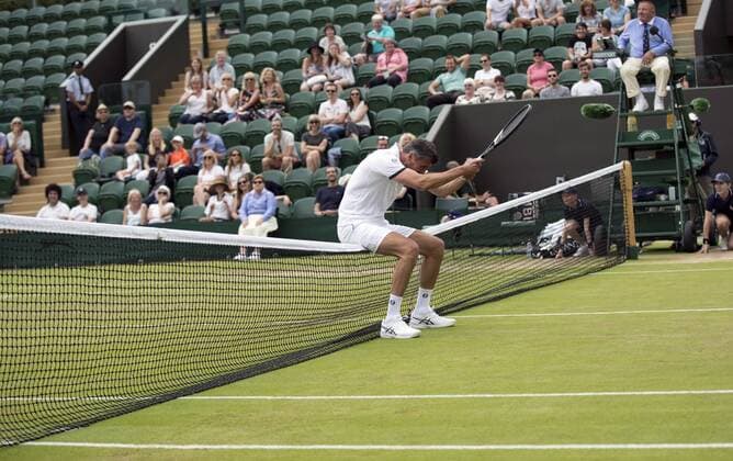 July 13th 2017, All England Lawn Tennis and Croquet Club, London, England; The Wimbledon Tennis Championships, Day 10; Goran Ivanisevic (CRO) rests on the court net awaiting a return of service during his match with Wayne Ferreira (RSA) against Jeremy Bates (GBR) and Chris Wilkinson (GBR) xRolandxHarrisonx  ActionPlus11900781