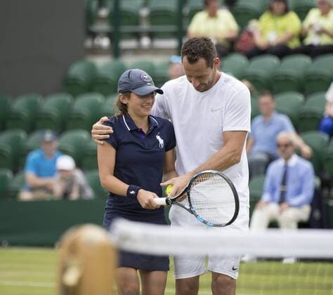 July 13th 2017, All England Lawn Tennis and Croquet Club, London, England; The Wimbledon Tennis Championships, Day 10; Michael Llordra (FRA) passes his racket to a Ball Girl so she can play during his match with Monsour Bahrami (IRI) against Greg Rusedski (GBR) and Fabrice Santoro (FRA) xRolandxHarrisonx  ActionPlus11900835