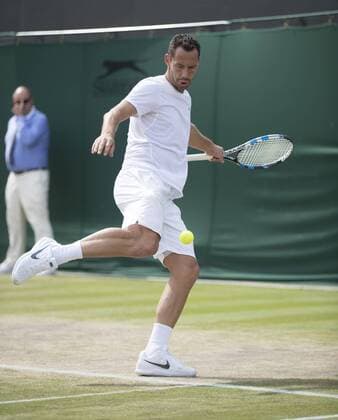 July 13th 2017, All England Lawn Tennis and Croquet Club, London, England; The Wimbledon Tennis Championships, Day 10; Michael Llordra (FRA) plays football with the tennis ball as he kicks the ball towards the Ball Boy during his match with Monsour Bahrami (IRI) against Greg Rusedski (GBR) and Fabrice Santoro (FRA) xRolandxHarrisonx  ActionPlus11900840