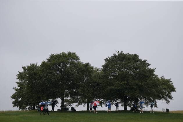 Patrons walk along the 16th fairway carrying umbrellas in the rain in the second round of the LPGA Golf Damen U.S. Women s Open Championship Trump National Golf Club in Bedminster, NJ on July 14, 2017.  NYP201707141152 JOHNxANGELILLO