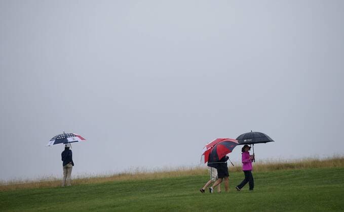 Patrons walk along the 16th fairway carrying umbrellas in the rain in the second round of the LPGA Golf Damen U.S. Women s Open Championship at Trump National Golf Club in Bedminster, NJ on July 14, 2017.  NYP201707141107 JOHNxANGELILLO