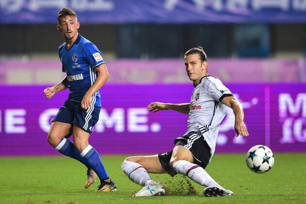 Donis Avdijaj of FC Schalke 04, left, challenges Turkish football player Atinc Nukan of Besiktas J.K. in a friendly soccer match in Zhuhai city, south China s Guangdong province, 19 July 2017. FC Schalke 04 defeated Besiktas J.K. 3-2. FC Schalke 04 defeats Besiktas J.K. at 2017 friendly soccer match in south China city  20170719_85476